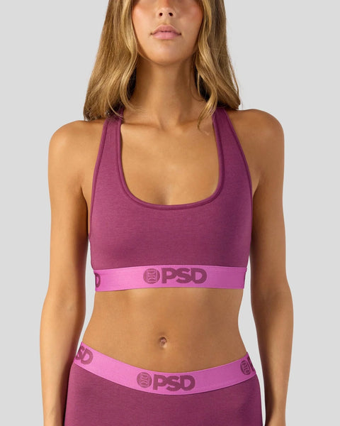 Magenta purple racerback sports bra with pink PSD branding waistband.