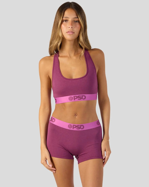 Purple racerback sports bra and matching boy shorts with pink waistband and logo detail.