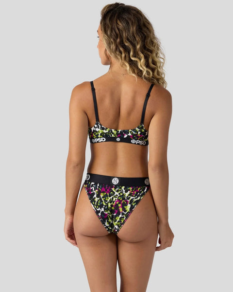 Woman wearing a two-piece swimsuit with neon leopard print pattern and black branded waistband, viewed from back.