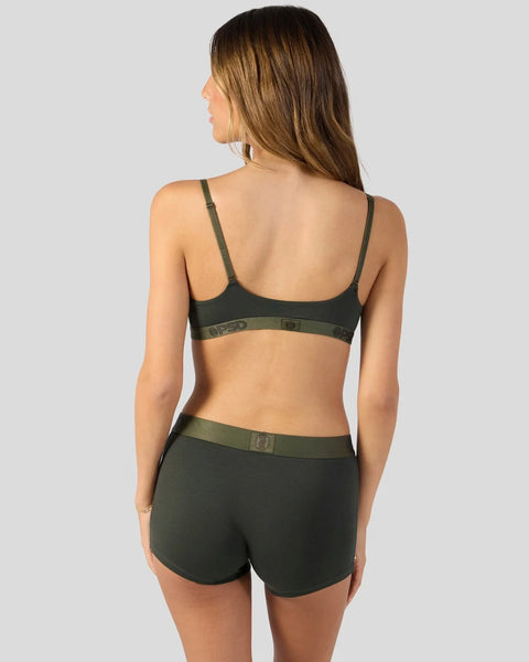 Woman wearing dark green modal bra and shorts set with adjustable straps and elastic waistband, shown from back view.