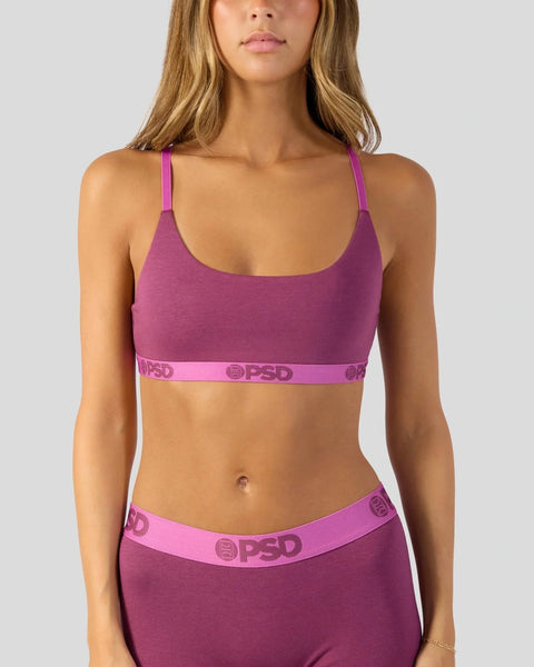 Magenta sports bra with matching waistband featuring branded elastic trim.