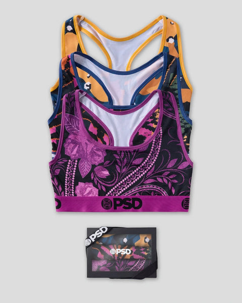 Three sports bras in orange, navy, and purple with floral patterns and matching packaging box.