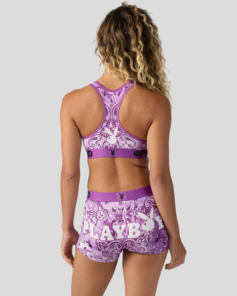 Purple Playboy-branded sports bra and shorts set with ornate paisley print and logo details.