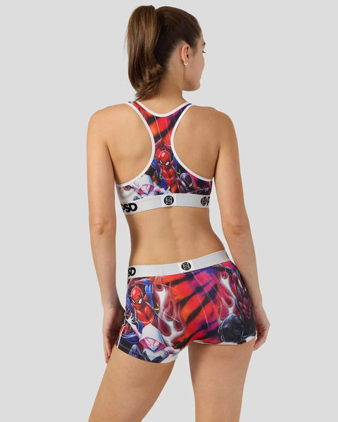 Woman wearing Spider-Man patterned sports bra and shorts set with red, blue and white colorway, shown from back view.