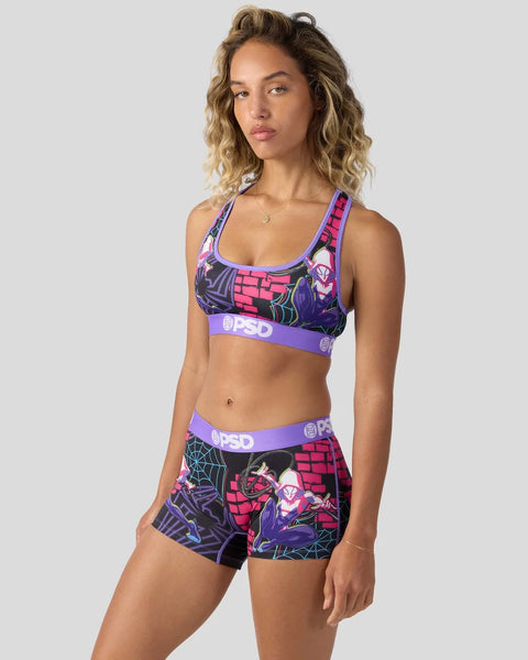 Woman wearing purple and pink Ghost-Spider sports bra and shorts set with neon graphics and PSD branding.