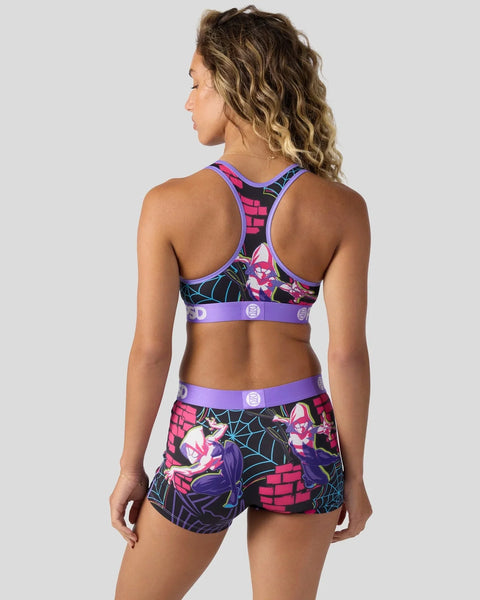 Woman wearing Ghost-Spider sports bra and shorts set with colorful comic-inspired print, purple trim, and racer-back design, 