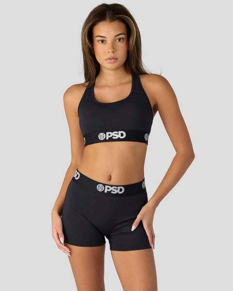 Black sports bra and shorts set with PSD branding on elastic waistbands.