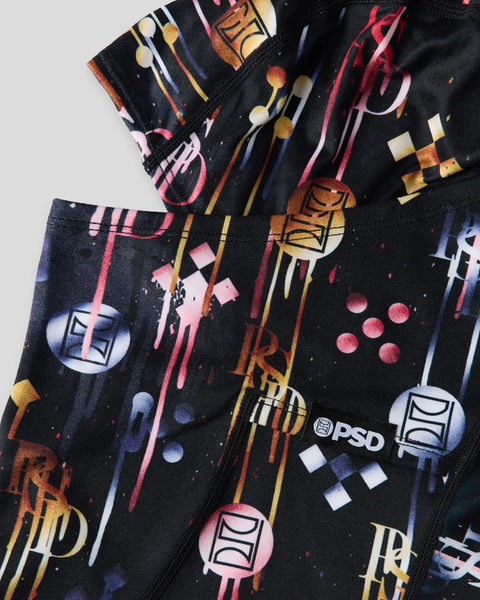 Black fabric with multicolored makeup brush and cosmetic product illustrations in pink, gold, and blue tones.