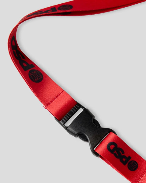 Red lanyard with black plastic buckle and adjustable neck strap featuring printed logo details.