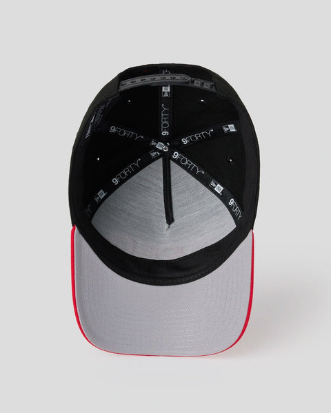 Black and red baseball cap with gray interior showing adjustable snap closure and branded tape detailing.