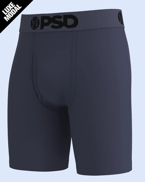 Dark purple boxer briefs with PSD brand waistband and center fly opening against light blue background.