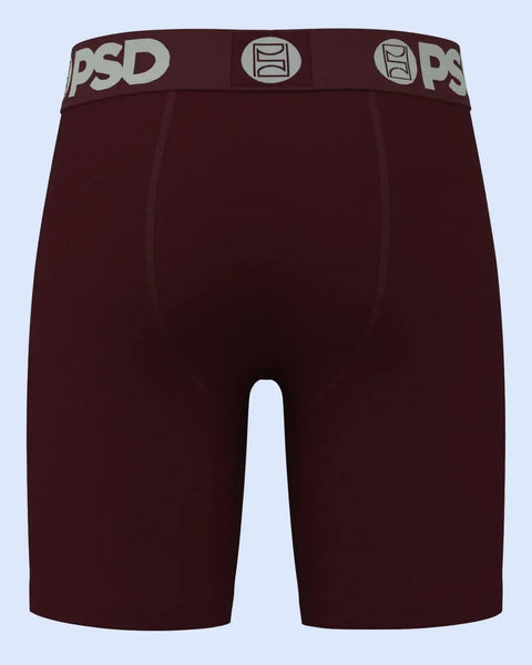 Burgundy boxer briefs with PSD branded waistband and center seams on light blue background.