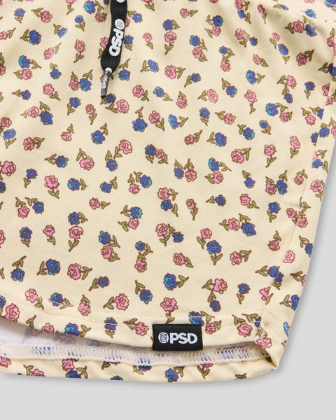 Cream camisole with scattered pink and blue floral print, brand tag visible at hem.