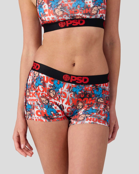 Women's sports bra and shorts set with red, blue, and white Chucky character print and black PSD waistbands.