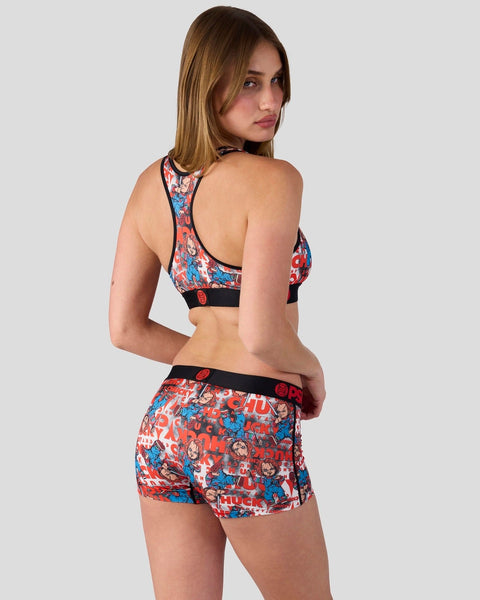 Woman wearing red, blue and white patterned sports bra and shorts set with character print design.
