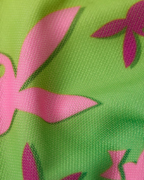 Lime green mesh fabric with pink and magenta geometric leaf shapes.