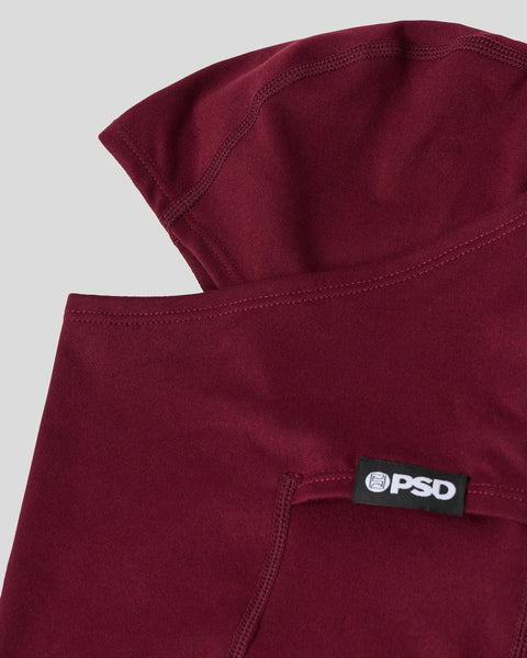 Dark burgundy fabric with PSD brand label and stitched seams visible on folded material.