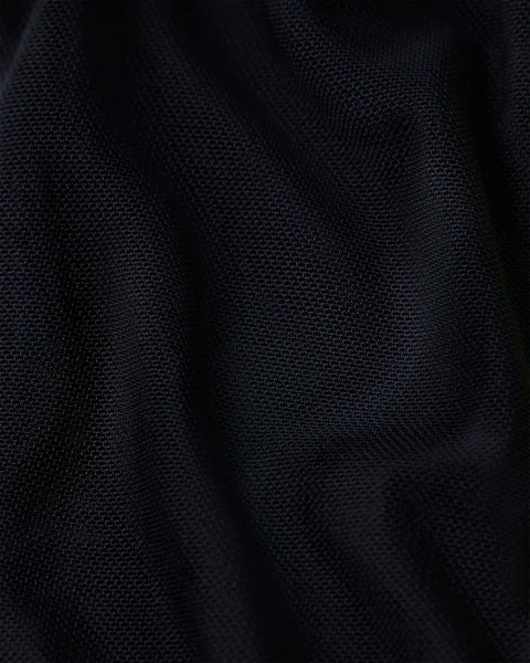 Black mesh fabric with visible woven texture and natural folds.
