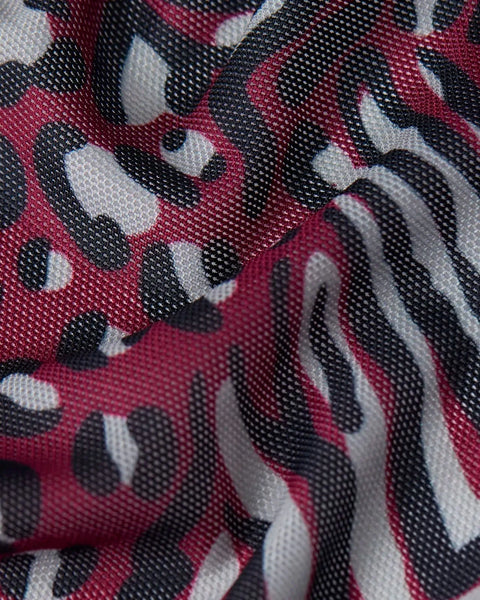 Mesh fabric with burgundy, black, and white cheetah spot pattern texture.