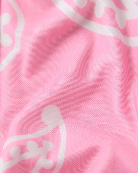 Pink mesh bandana with white paisley pattern and textured fabric surface.