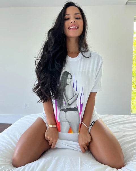 White oversized tee with large graphic print featuring portrait and colorful gradient design on front.